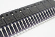 Close-up of electronic components with 'IRFP9140NPBF' branding on a metallic surface.